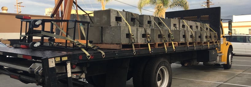 yellow truck with four hundred pound ballast loaded in back of it